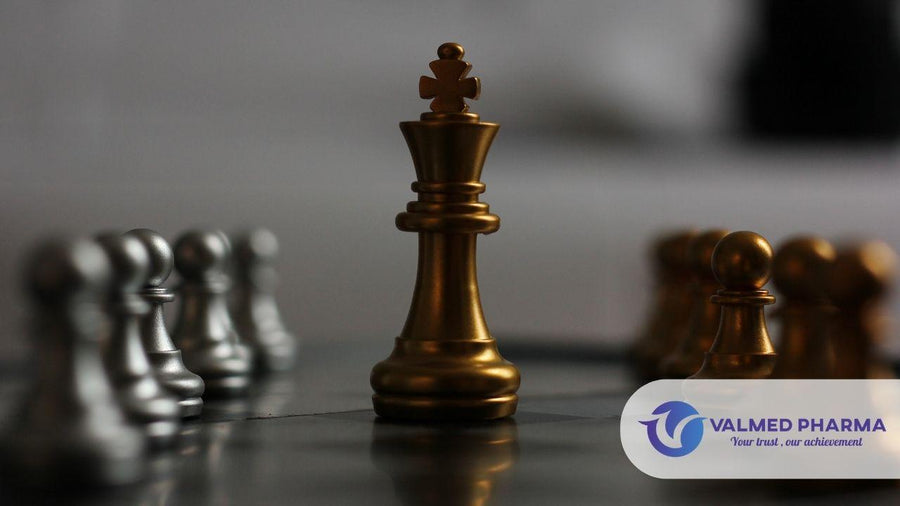 Gold king and pawns facing silver chess pieces on a chessboard, with Valmed Pharma branding.